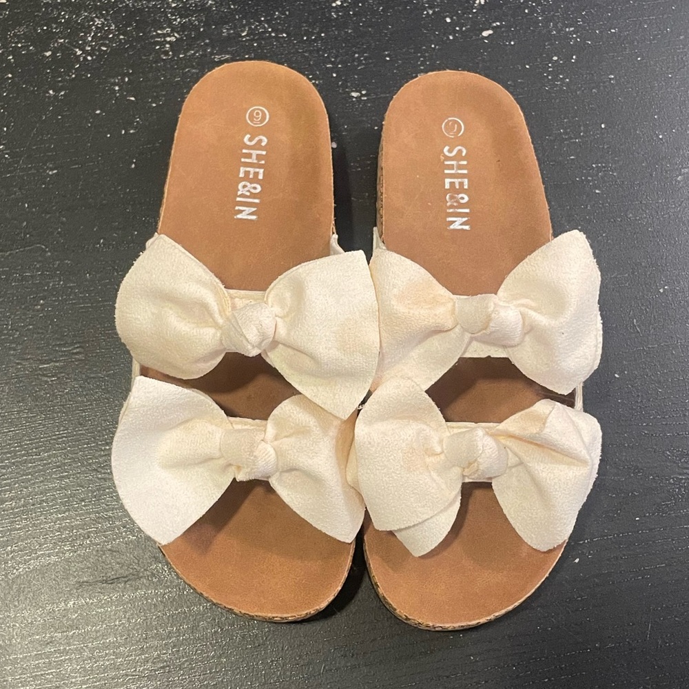 White creamed bowed sandals